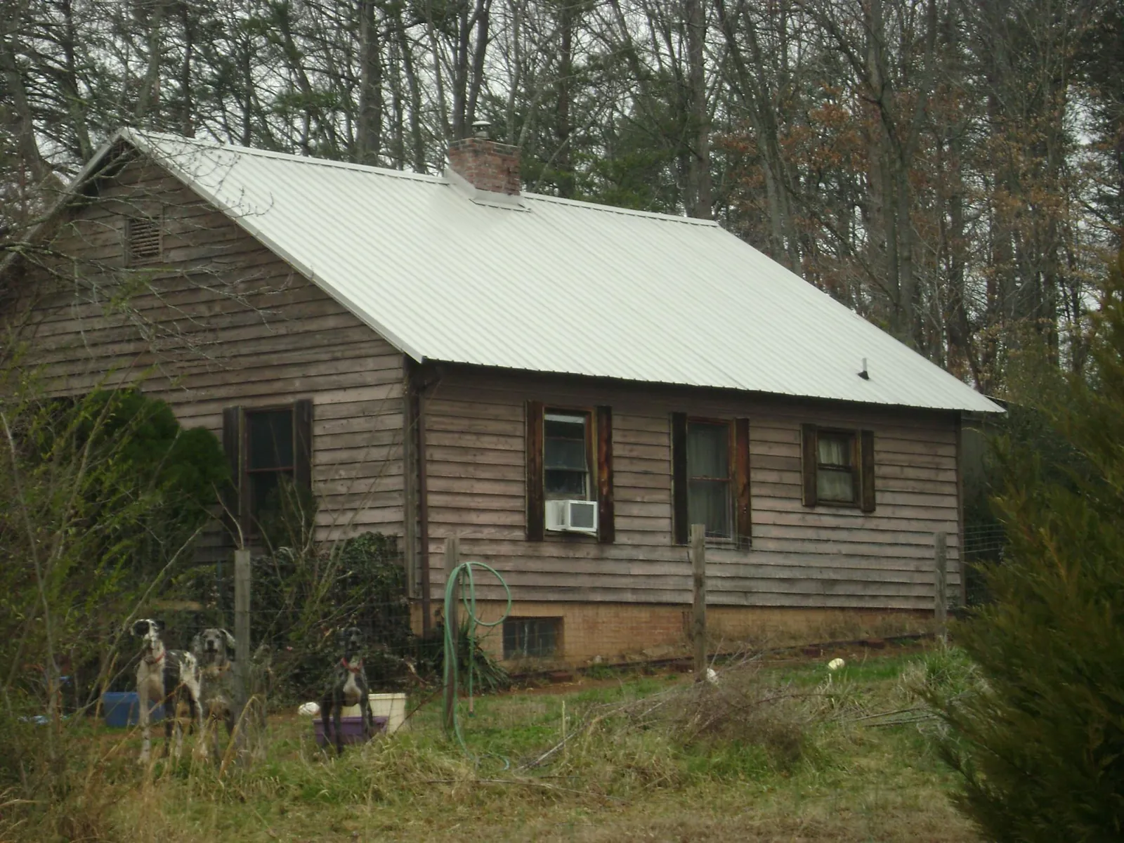 White metal roof on an old wood sided farmhouse, from a Metal Roof Installation job in Southwick